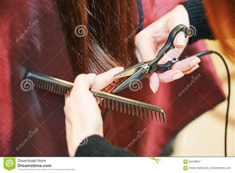 Hands Of Professional Hair Stylist With Scissors And Comb Stock Image