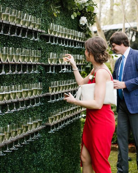 martha stewart weddings on instagram “a boxwood wall decked out with flutes of champagne yes