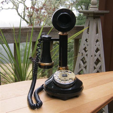 An Old Fashioned Phone Sitting On Top Of A Wooden Table