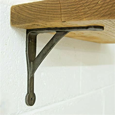 A Wooden Shelf With Metal Brackets On It