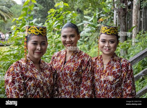 Three Friendly Women In Traditional Costume In The Sarawak Cultural Village Kampung Budaya