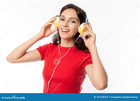 Cheerful Beautiful Young Lady Listening Music By Using Headphone With