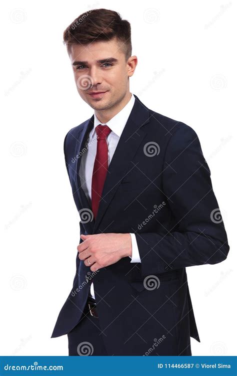 Handsome Businessman Smiling And Buttoning His Navy Suit Stock Image
