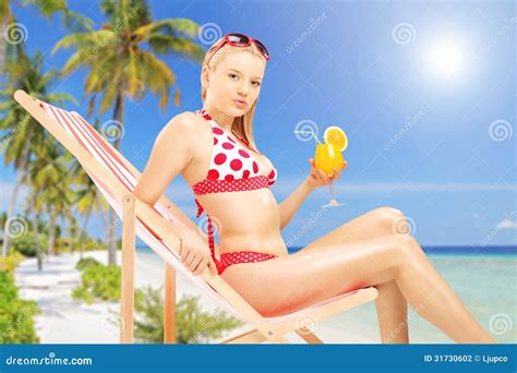 Attractive Female Holding A Cocktail And Sitting On A Sun Lounge Stock Photo Image Of Female