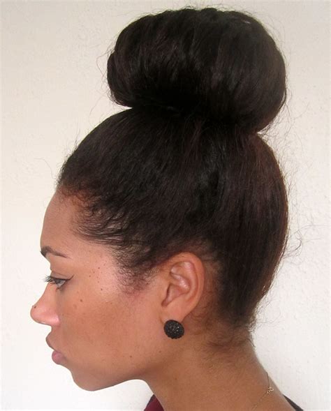 Part your hair in the middle to create two sections. High Bun