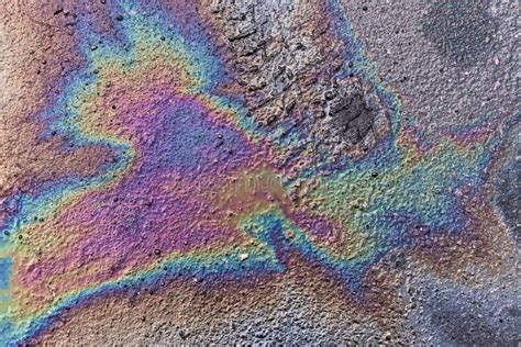 Gasoline Spot On Wet Asphalt Multi Colored Oil Spill On Asphalt Road