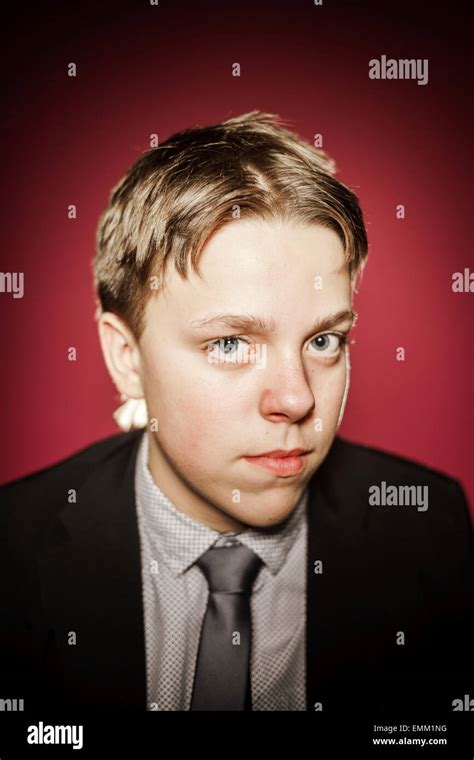 Affective Teenage Boy Close Up Portrait In Studio Isolated On Red