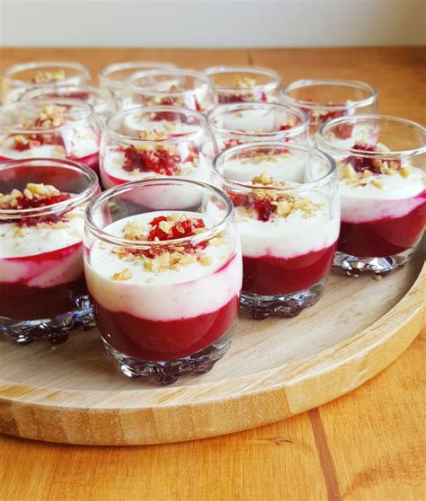 Desserts Are Arranged In Small Glass Dishes On A Wooden Platter Ready