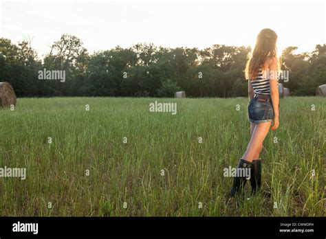 Woman Standing In Grassy Field Stock Photo Alamy