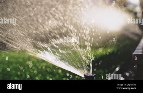 Watering The Grass Slow Motion Water Spraying Out Of Sprinkler On The