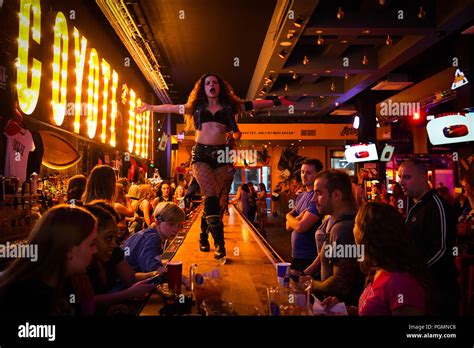 Inside A Coyote Ugly Bar Where Women Dance On The Bar As People Order Drinks Inspired By The