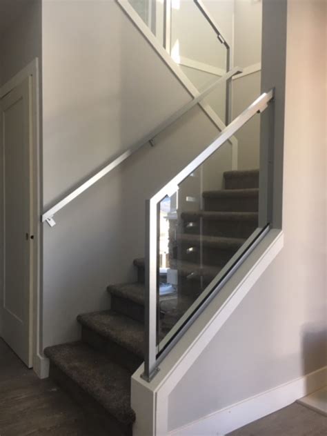 Silver wrought iron stair rails, description: metal interior stair railing, glass, silver, modern