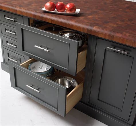 At a minimum, an island adds counter and storage space just where you need them: Deep drawers in this kitchen island store pots and pans ...