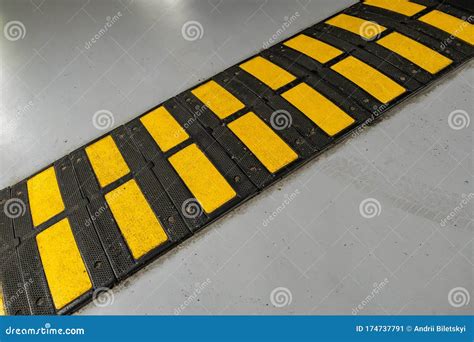 Striped Black And Yellow Speed Bump On A Road Stock Image Image Of