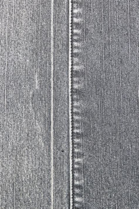 Texture Of A Gray Denim Fabric Two Pieces Of Fabric Stitched Together