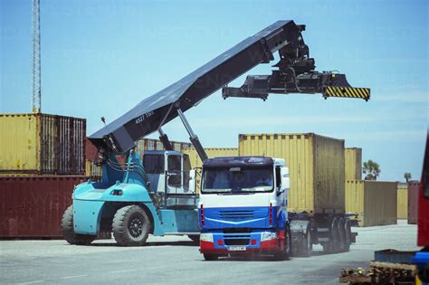 Crane Near Cargo Container On Truck Stock Photo