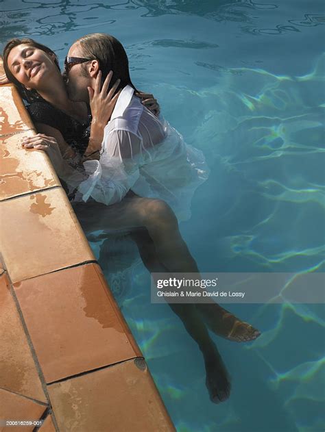 Man Kissing Womans Neck In Swimming Pool Photo Getty Images