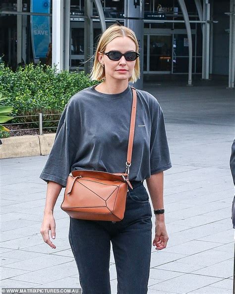 Lara Bingle Shows Off Her Edgy Fashion Sense As She Jets Into Sydney