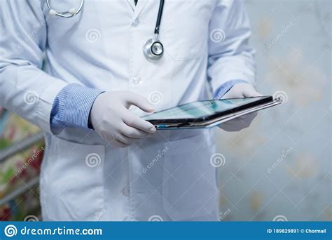 Doctor Holding Digital Tablet To Search Data For Treat Patient In