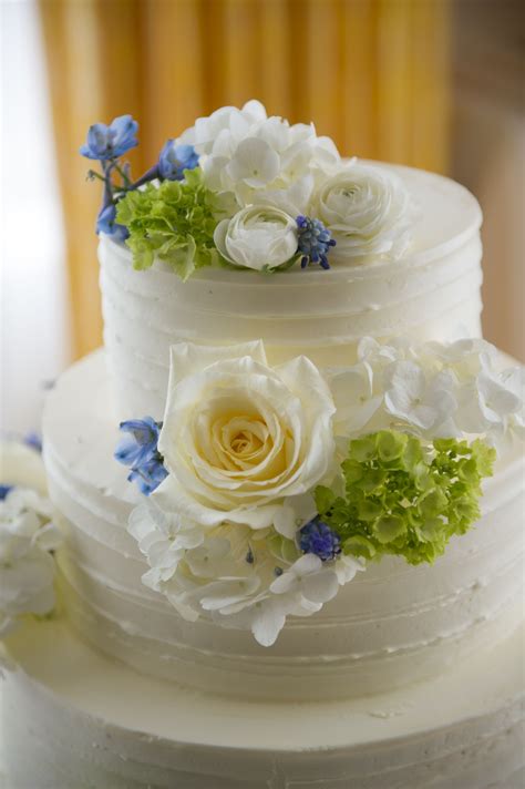 Three Tier Buttercream Wedding Cake With White Blue And Green Flowers