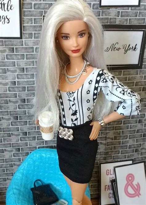 A Barbie Doll Is Standing Next To A Coffee Cup