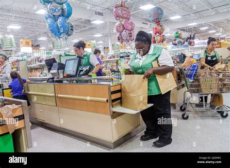 Bagger bagging black woman female women employee worker working hi-res