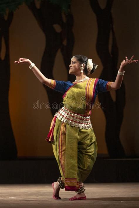beautiful female classical odissi dancer performing odissi dance on stage in special attire at