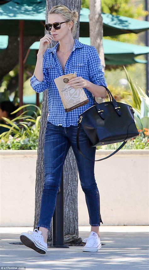 Charlize Theron Turns Heads In Form Fitting Jeans And Unbuttoned Shirt