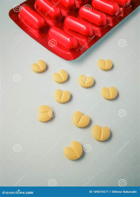 Heart Shaped Yellow Pills Creative Healthcare And Medicine Concept