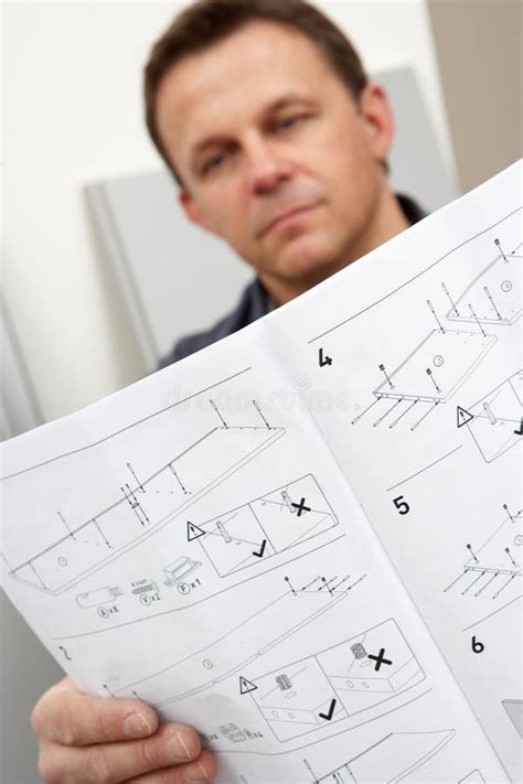 Man Reading Assembly Instructions For Flat Pack Stock Image Image Of