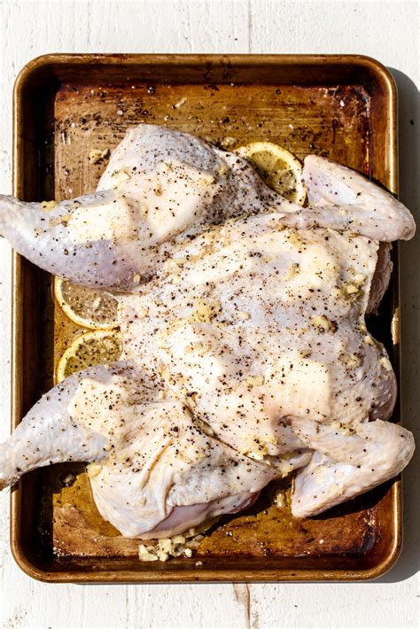 Lemon And Garlic Spatchcocked Chicken Cooking With Cocktail Rings