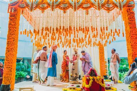 Photo of South indian mandap decor idea with orange theme Wedding Hall