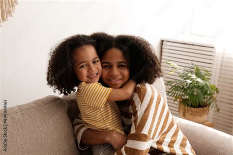 Younger And Older Sister Spending Time Together At Home Two Black