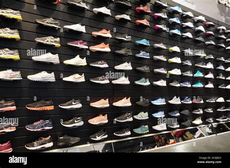 Shop Display Of A Lot Of Sports Shoes On A Wall A View Of A Wall Of