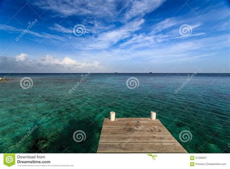 Dock Looking Over Tropical Blue And Turquoise Waters In Caribbean Stock