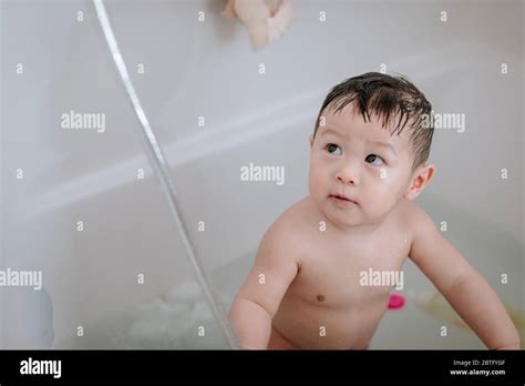 Little Baby Boy Playing In Bathtub At Home Stock Photo Alamy