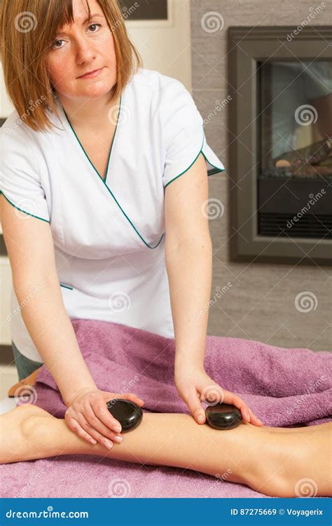 Masseuse Doing Legs Massage With Hot Stones Stock Image Image Of Lying Beautician