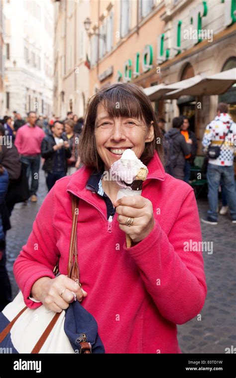 A Middle Aged Caucasian Woman Tourist In Her 50s Enjoying And Italian Ice Cream Rome Italy