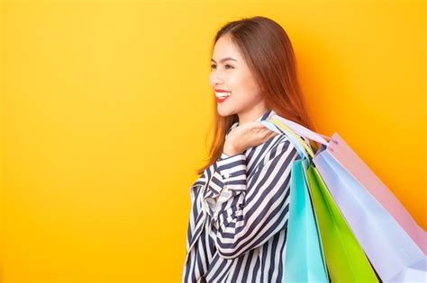 Premium Photo Happy Shopping Woman On Yellow Background