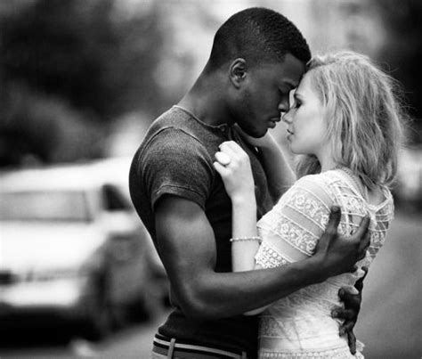 Black And White Photograph Of A Man Kissing A Blonde Haired Woman On