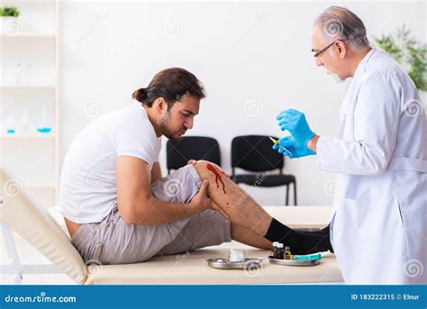 Leg Injured Man Visiting Old Doctor In First Aid Concept Stock Image