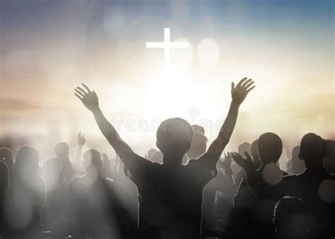 Silhouette Human Raising Hands To Praying God On Blurred Cross