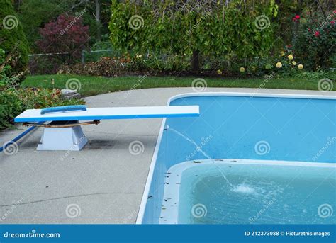 Backyard Swimming Pool With Diving Board Emptied Out Shutting Down For