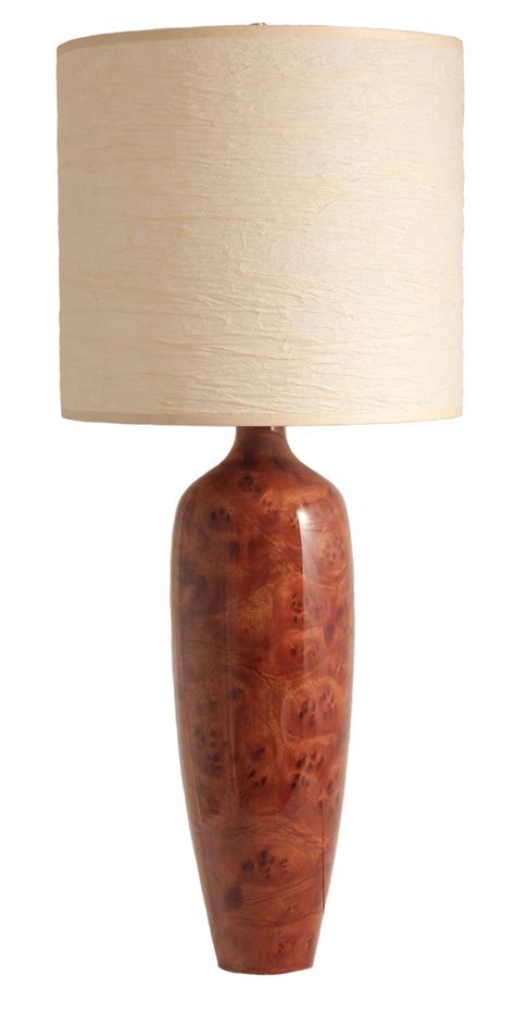 Maybe you would like to learn more about one of these? This is a tall thin table lamp with a camphor burl base ...
