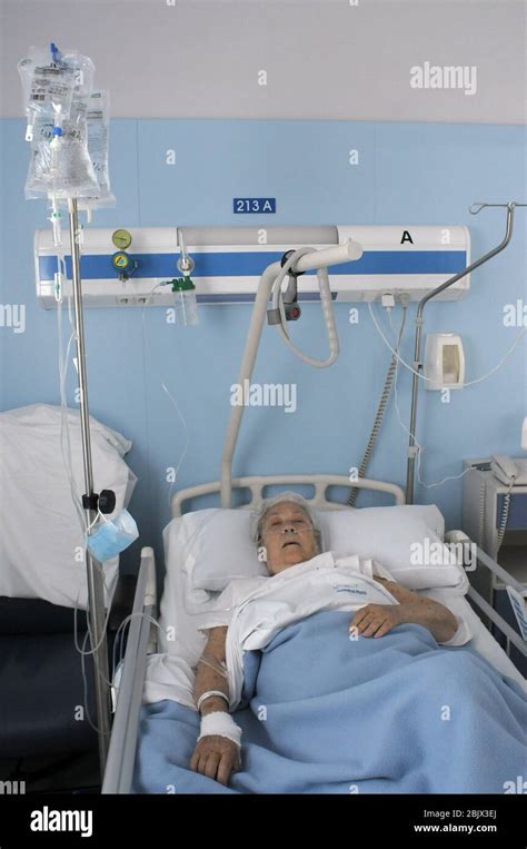 Woman Stretched Out In A Hospital Bed Connected With Different Routes