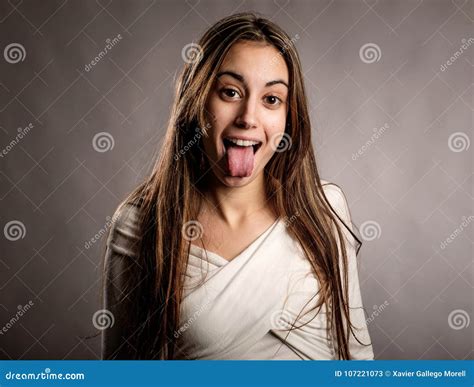 Portrait Of Young Woman Showing Tongue Stock Image Image Of Gray