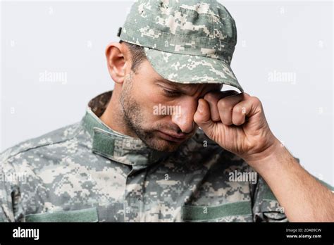 Sad Military Man In Uniform And Cap Wiping Tears While Crying Isolated