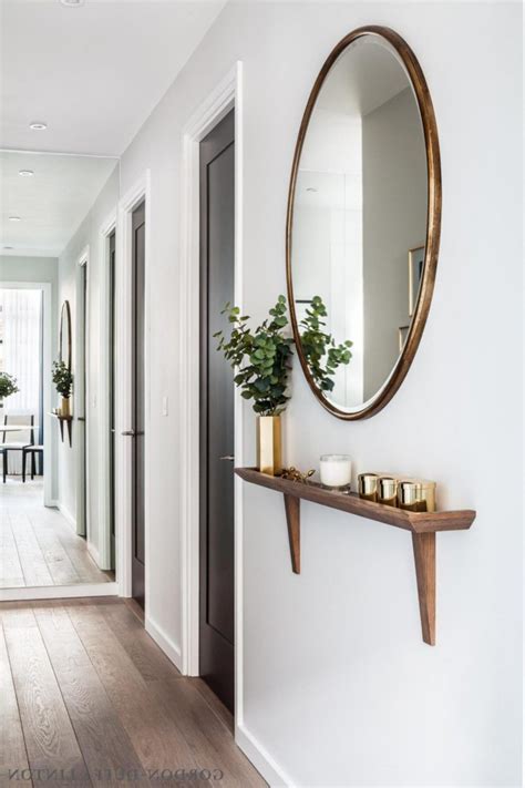 Modern Entryway Mirror With Hooks This Round Mirror Is Encased In A