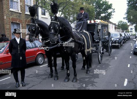 Traditional English Funeral With Black Horses Carriage And Attendants