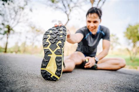 Close Up Shot Of Runner Stretching His Leg Stock Photo Image Of
